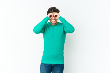 Fototapeta premium Young cool man showing okay sign over eyes