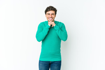 Fototapeta premium Young cool man keeps hands under chin, is looking happily aside.
