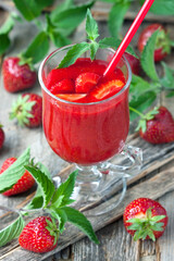 Strawberry  smoothie in glass with cocktail straw, selective focus