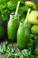 Fresh organic green smoothie with vegetables and greens