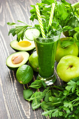 Fresh organic green smoothie with vegetables and greens