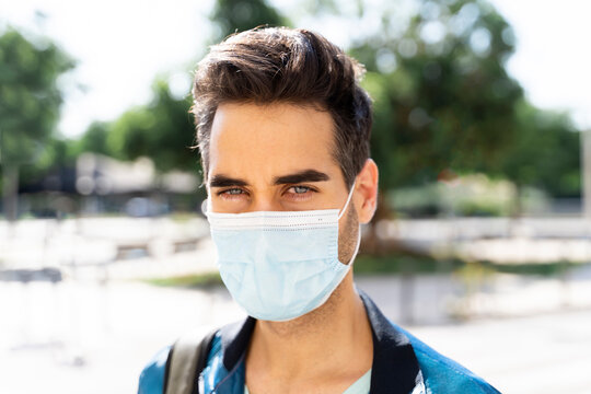 Man wearing protective face mask in city during COVID-19