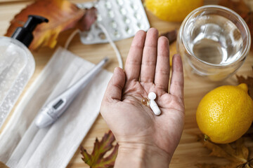 Vitamin D, vitamin C and zinc pills in senior hand, Boost immune system in autumn flu or covid