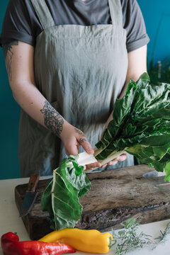 Young woman preparing pak choi
