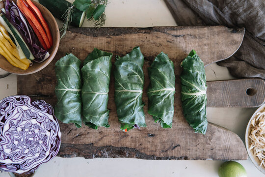 Vegan rolls with vegetables on cutting board