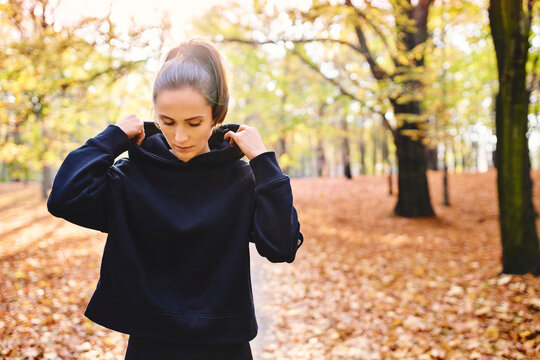 Young female jogger in autumn forest
