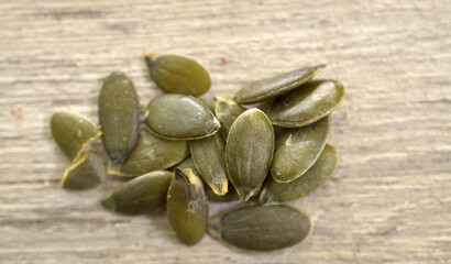 Pumpkin Seeds on wood Background