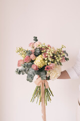 Fototapeta premium Studio shot of pink and yellow bouquet of summer flowers