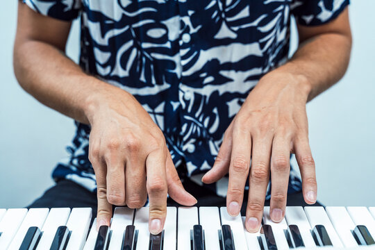 Man playing piano while sitting