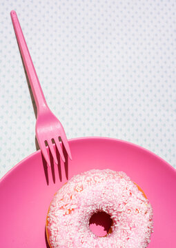 Plastic fork and plate with sweet doughnut