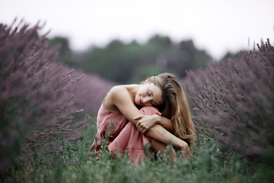 Woman sitting in lavender field