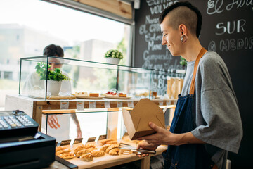 Waiter and customer at the counter in a cafe