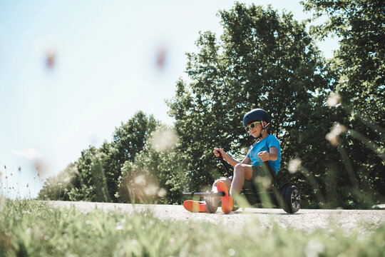 Boy enjoying hoverkart ride at skateboard park on sunny day