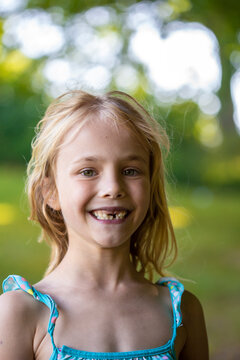 Cute girl with gap toothed standing outdoors