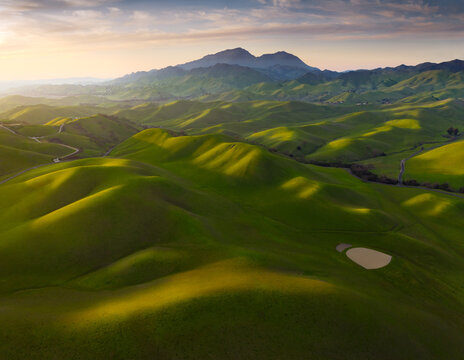 Scenic view of rolling hills during sunrise