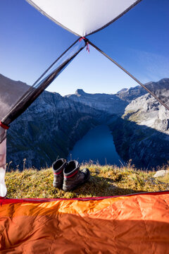 Tent pitched at edge of Limmerensee reservoir canyon