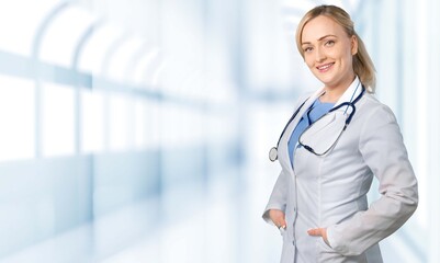 Attractive female doctor on hospital background