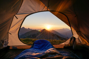 Tent pitched in Allgau Alps at sunset with Sulzspitze in background