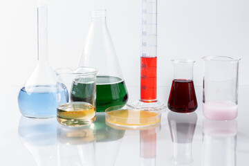 Glass laboratory apparatus with color water on the glass table