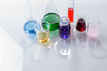 Glass laboratory apparatus with color water on the glass table