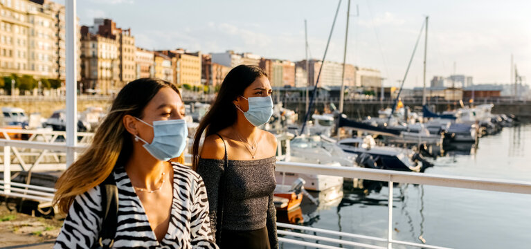 Young Women Wearing Protective Face Mask In City