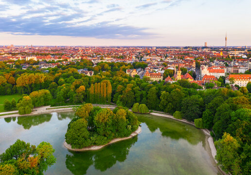 Germany, Bavaria, Munich, Drone view of Kleinhesseloher See and Electors Island in English Garden at dawn