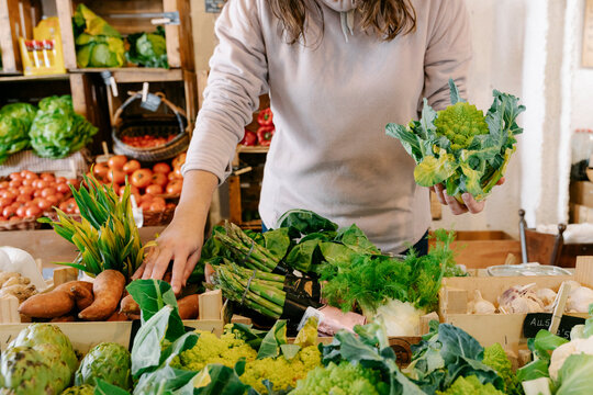 Woman picking fresh healthy vegetable at store