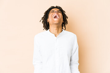 Young african american rasta man relaxed and happy laughing, neck stretched showing teeth.