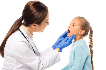 Selective focus of smiling pediatrician in latex gloves looking at girl with open mouth isolated on white