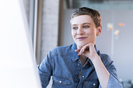 Portrait of smiling businesswoman at desk in office