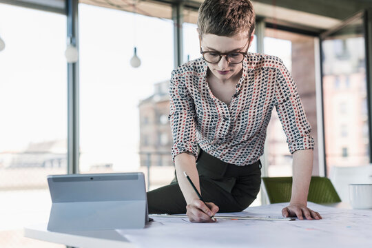Businesswoman working on plan in office