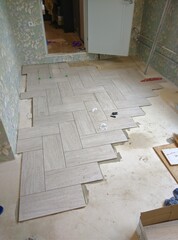 Bricklayer placing a porcelain stoneware floor