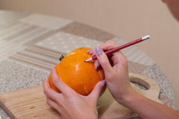 the process of making a Halloween pumpkin. drawing a layout. horror theme and Hallowe'en. 