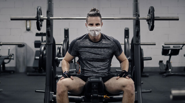 Pandemic Gym - Man Working Out With Protective Face Mask During Coronavirus Outbreak