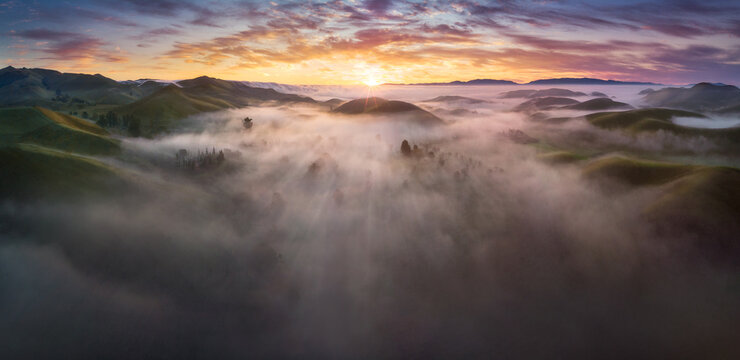 Fototapeta View of fog over forest during sunrise