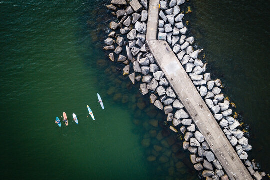 Aerial view of men standup paddleboarding at Muskegon Harbor