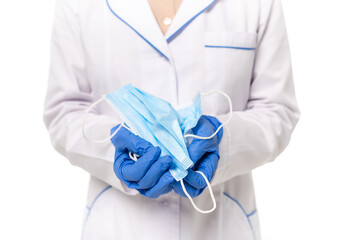 Cropped view of doctor in latex gloves holding medical masks isolated on white