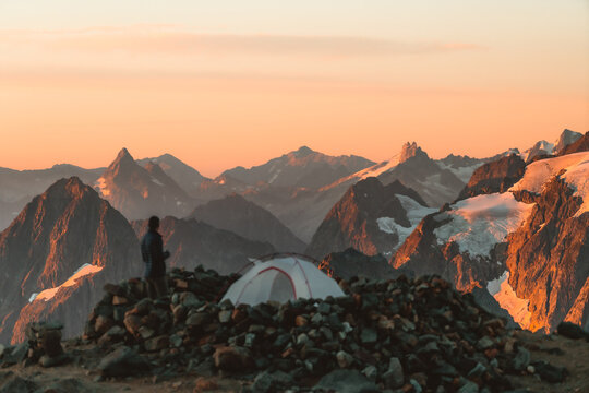 Hiker looking at view while standing by tent