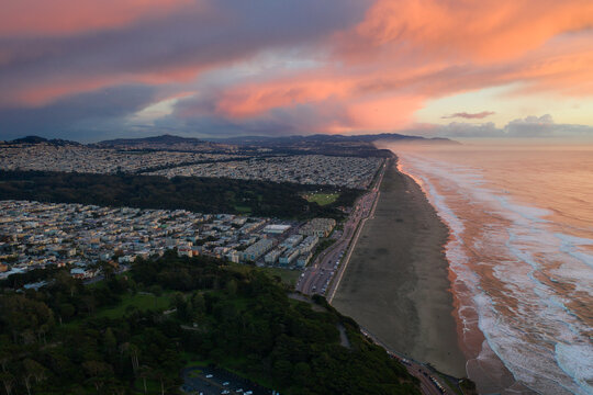 High angle view of sunset over cityscape and coastline