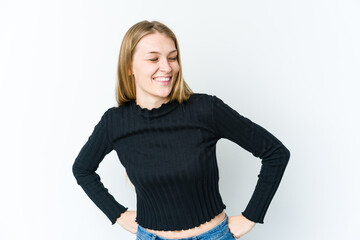 Young blonde woman isolated on white background laughs happily and has fun keeping hands on stomach.