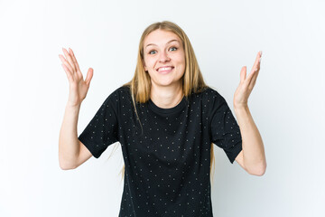 Fototapeta na wymiar Young blonde woman isolated on white background receiving a pleasant surprise, excited and raising hands.