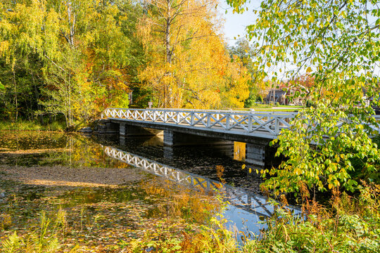 Autumn view of the river and white wooden bridge, Stromfors Iron Works, Loviisa, Finland
