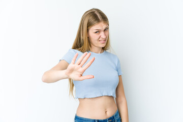 Young blonde woman isolated on white background rejecting someone showing a gesture of disgust.