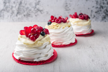 Pavlova meringue cake with cream and raspberries, blueberries, strawberries, currants