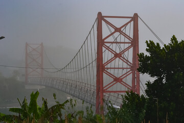 Sekrikil suspension bridge in Parakan city, Central Java, Indonesia on a foggy morning