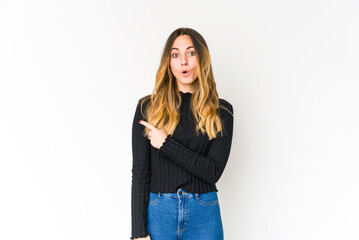 Young caucasian woman isolated on white background pointing to the side