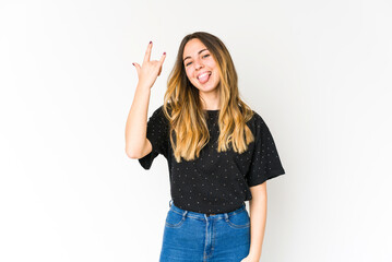 Young caucasian woman isolated on white background showing rock gesture with fingers