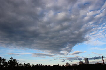 Blue Sky in evening with clouds. Big city buildings silhoutes panorama. City life concept - Powered by Adobe