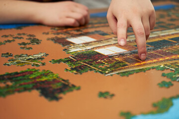 Fototapeta premium Man collects mosaic. Folding puzzle.