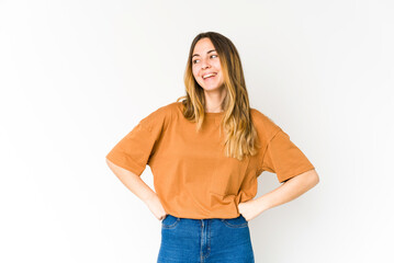 Fototapeta premium Young caucasian woman isolated on white background laughs happily and has fun keeping hands on stomach.